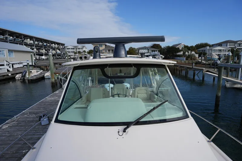 Slide: The Image of 2024 Grady-White Express 330 docked at a marina, showcasing its sleek design. - 74