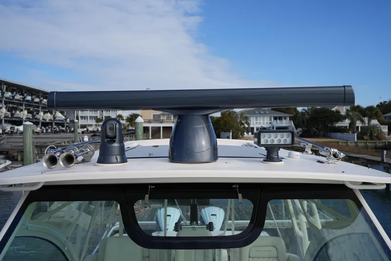 Slide: The Image of 2024 Grady-White Express 330 boat with radar and navigation equipment on deck. - 75