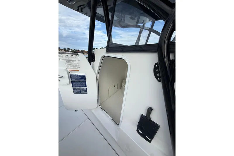 Slide: The Image of 2020 SeaHunter 41 CTS boat docked in a serene marina setting. - 10