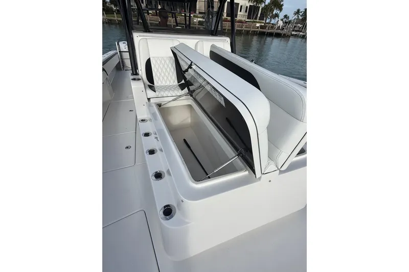 Slide: The Image of 2020 SeaHunter 41 CTS boat with four powerful outboard engines docked near a modern house. - 20