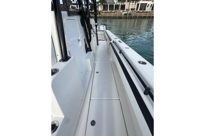 Slide: The Image of 2020 SeaHunter 41 CTS boat deck with speakers and anchor, on calm water. - 21