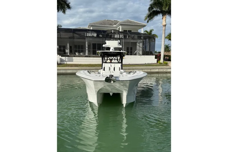 Slide: The Image of 2020 SeaHunter 41 CTS boat docked in a serene waterfront setting. - 3