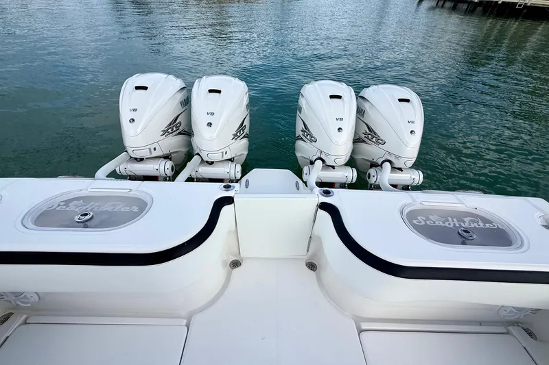 Slide: The Image of 2020 SeaHunter 41 CTS boat with four Yamaha V8 engines on calm water. - 46