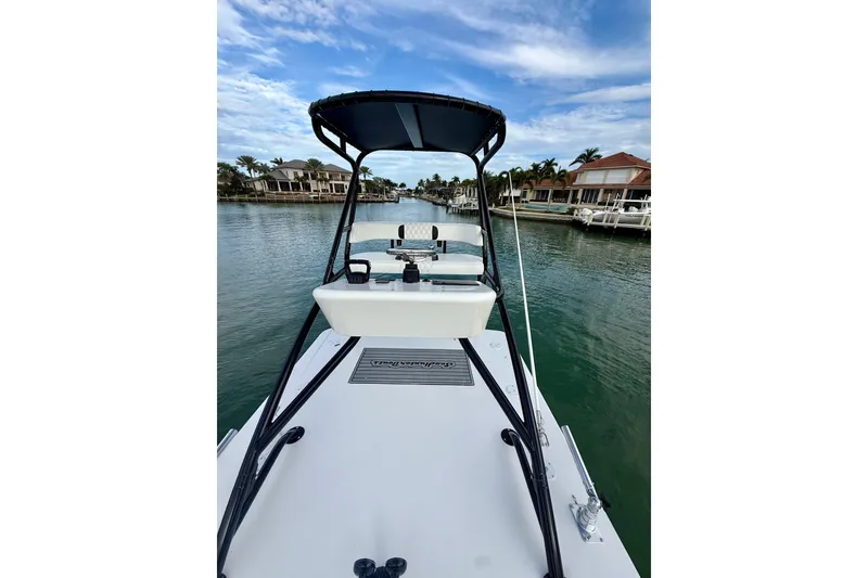 Slide: The Image of 2020 SeaHunter 41 CTS boat on a calm waterway, surrounded by waterfront homes. - 48