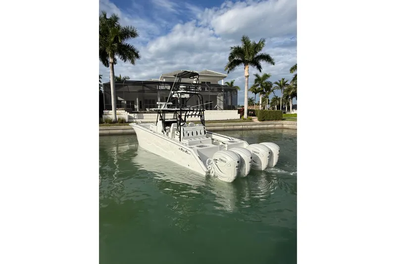 Slide: The Image of 2020 SeaHunter 41 CTS boat with four powerful engines docked in a serene marina. - 5