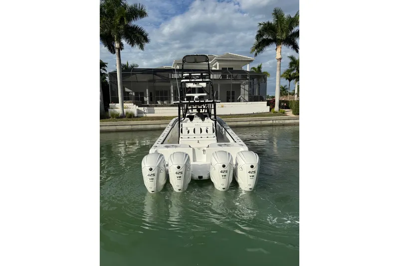 Slide: The Image of 2020 SeaHunter 41 CTS boat with four powerful 425 V8 engines docked in a serene marina. - 6