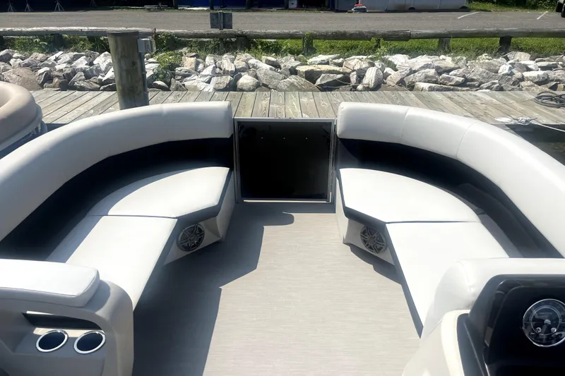 Slide: The Image of 2025 Harris Breeze 230 pontoon boat interior with plush seating and cup holders. - 4