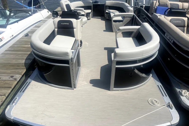 Slide: The Image of 2025 Harris Breeze 230 pontoon boat with spacious seating and modern design. - 5