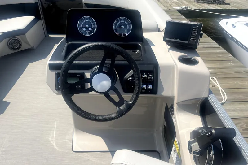 Slide: The Image of Steering console of 2025 Harris Breeze 230 pontoon boat with modern controls and gauges. - 8