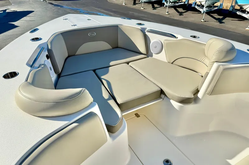 Slide: The Image of 2021 Key West 263 FS boat interior with beige seating and cup holders. - 10