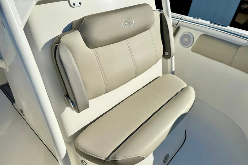 Slide: The Image of 2021 Key West 263 FS boat seat with beige upholstery and armrests. - 16