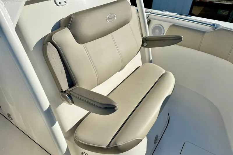Slide: The Image of 2021 Key West 263 FS boat seat with armrests, featuring beige upholstery. - 17