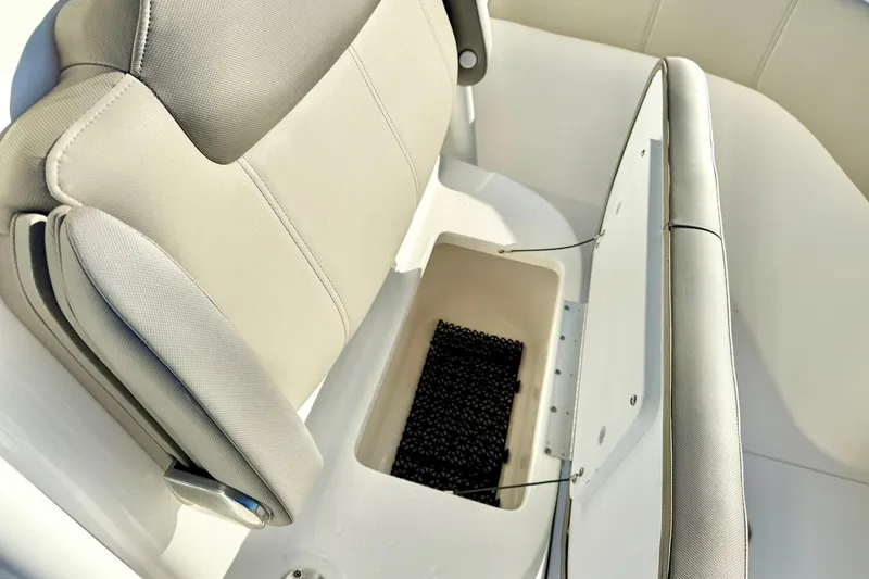Slide: The Image of 2021 Key West 263 FS boat seat with storage compartment open. - 18
