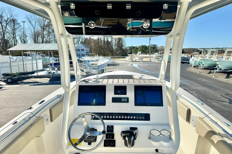 Slide: The Image of 2021 Key West 263 FS boat dashboard with dual screens and steering wheel. - 20