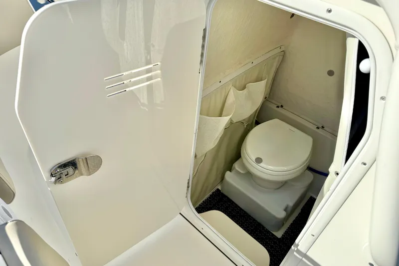 Slide: The Image of 2021 Key West 263 FS boat interior with compact marine toilet. - 23