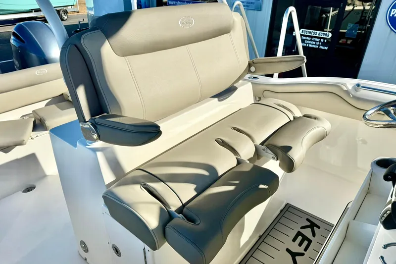 Slide: The Image of 2021 Key West 263 FS boat interior with comfortable seating and steering wheel. - 25