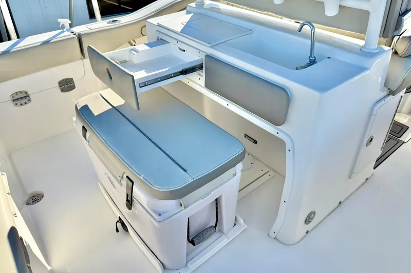 Slide: The Image of 2021 Key West 263 FS boat interior with seating, storage, and sink. - 27