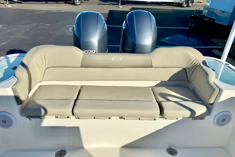 Slide: The Image of 2021 Key West 263 FS boat with beige seating and dual engines. - 29