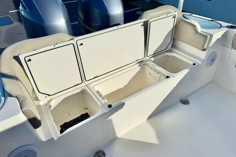 Slide: The Image of 2021 Key West 263 FS boat with open storage compartments and Yamaha engines. - 30