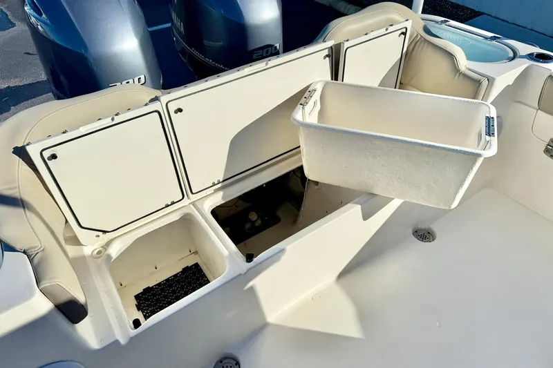 Slide: The Image of 2021 Key West 263 FS boat storage compartments and seating area with Yamaha engines. - 31