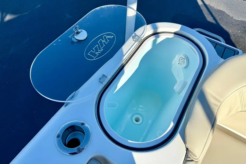 Slide: The Image of Livewell on 2021 Key West 263 FS boat, featuring open lid and seating area. - 32