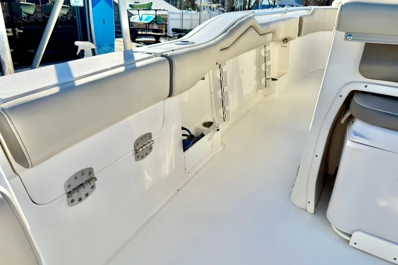 Slide: The Image of 2021 Key West 263 FS boat interior with cushioned seating and storage compartments. - 35