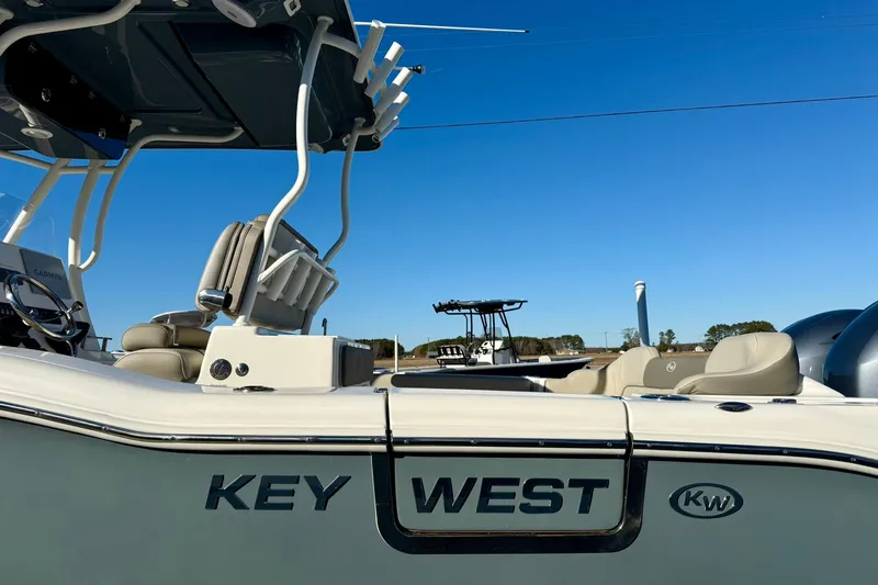 Slide: The Image of 2021 Key West 263 FS boat with seating and console, under clear blue sky. - 36