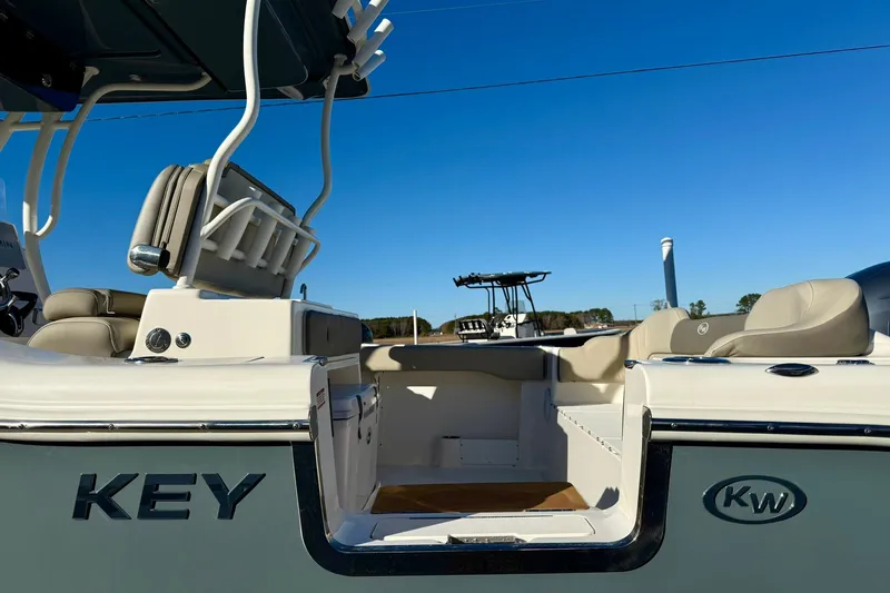 Slide: The Image of 2021 Key West 263 FS boat interior with seating and rod holders under clear blue sky. - 37