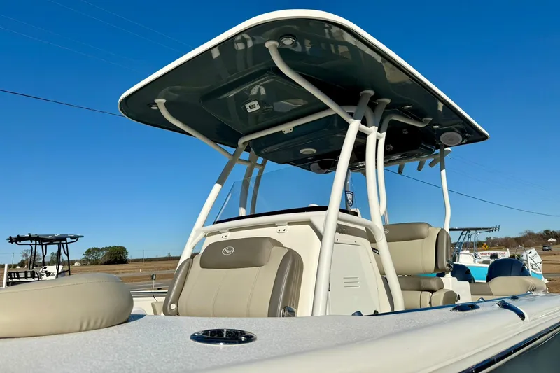 Slide: The Image of 2021 Key West 263 FS boat with T-top and seating, under clear blue sky. - 39