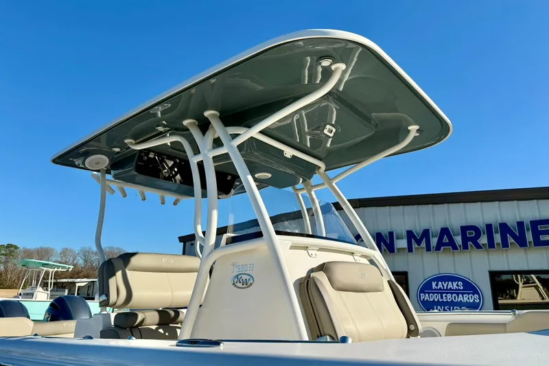 Slide: The Image of 2021 Key West 263 FS boat with T-top, displayed at a marine dealership. - 40