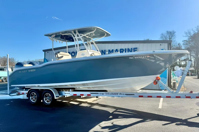 Slide: The Image of 2021 Key West 263 FS boat on trailer, parked outside marine dealership. - 6
