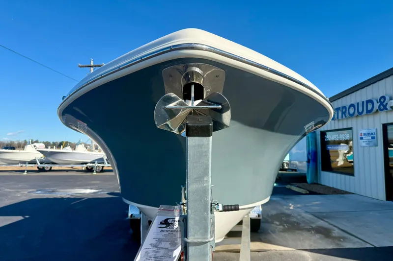 Slide: The Image of 2021 Key West 263 FS boat on trailer at dealership under clear blue sky. - 8