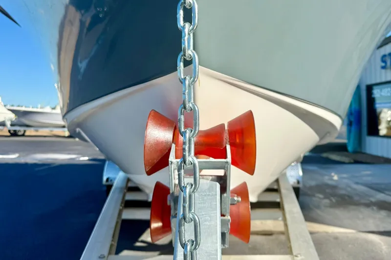Slide: The Image of 2021 Key West 263 FS boat on trailer with red rollers and chain. - 9