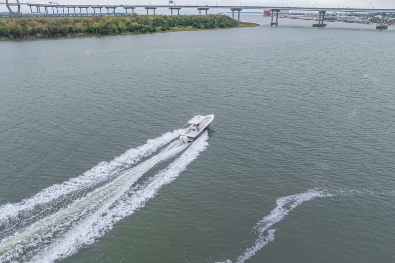 Slide: The Image of Aerial view of 2008 Jupiter 31 FS boat cruising on a river near a bridge. - 19
