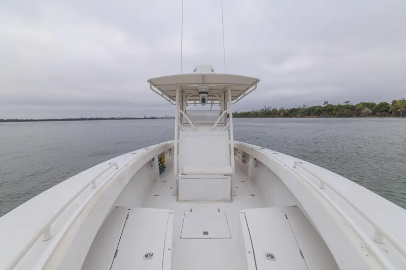 Slide: The Image of 2008 Jupiter 31 FS boat on calm water, overcast sky, and distant shoreline. - 27