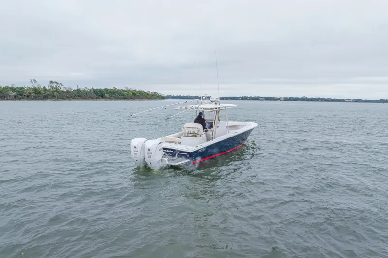 Slide: The Image of 2008 Jupiter 31 FS boat on open water, overcast sky, distant shoreline. - 3