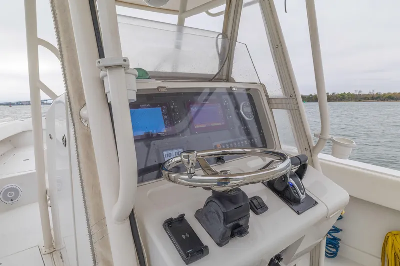 Slide: The Image of 2008 Jupiter 31 FS boat helm with navigation screens and steering wheel. - 30