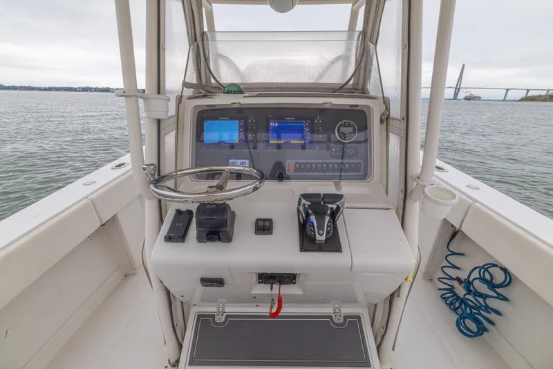 Slide: The Image of 2008 Jupiter 31 FS boat cockpit with steering wheel and navigation equipment. - 31