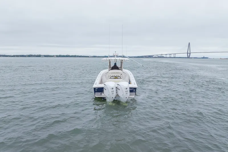 Slide: The Image of 2008 Jupiter 31 FS boat on water near a bridge under cloudy skies. - 4