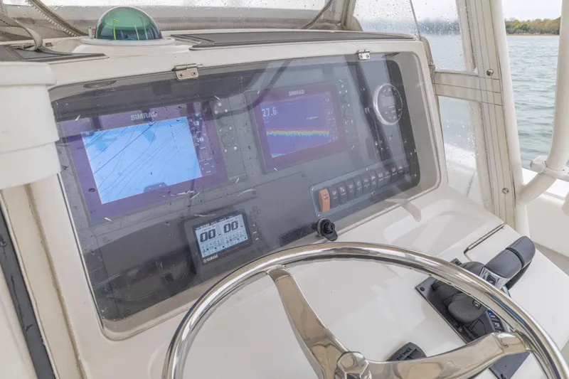 Slide: The Image of 2008 Jupiter 31 FS boat dashboard with navigation screens and steering wheel. - 41