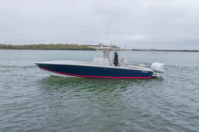 Slide: The Image of 2008 Jupiter 31 FS boat on calm water, side view, overcast sky. - 6