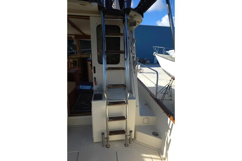 Slide: The Image of 2004 Legacy Yachts Sedan Flybridge ladder and interior view. - 19