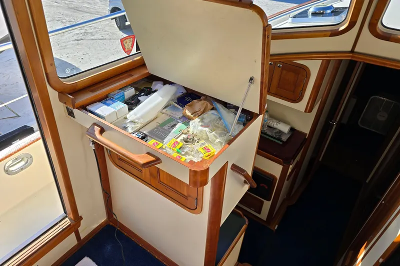 Slide: The Image of 2004 Legacy Yachts Sedan Flybridge interior with open storage compartment. - 8