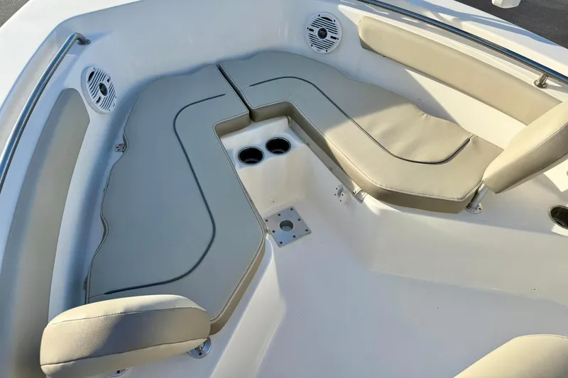 Slide: The Image of 2024 Key West 203 FS boat interior with cushioned seating and cup holders. - 10