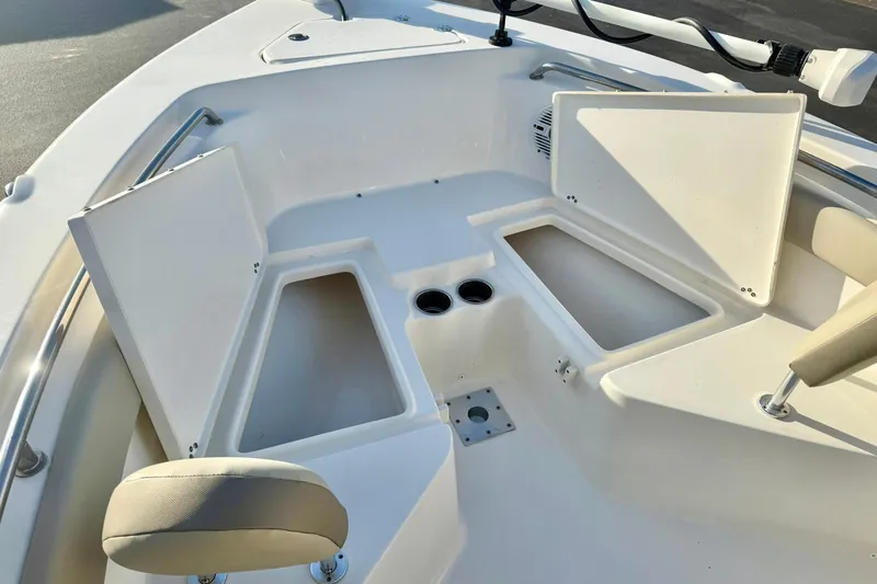 Slide: The Image of 2024 Key West 203 FS boat interior with open storage compartments and seating. - 12