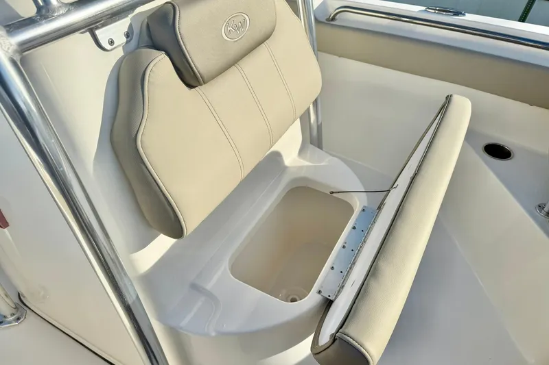 Slide: The Image of 2024 Key West 203 FS boat seat with storage compartment, featuring beige upholstery. - 17