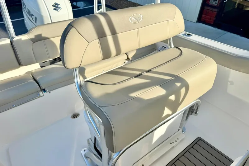 Slide: The Image of 2024 Key West 203 FS boat seating with beige upholstery and stainless steel frame. - 23