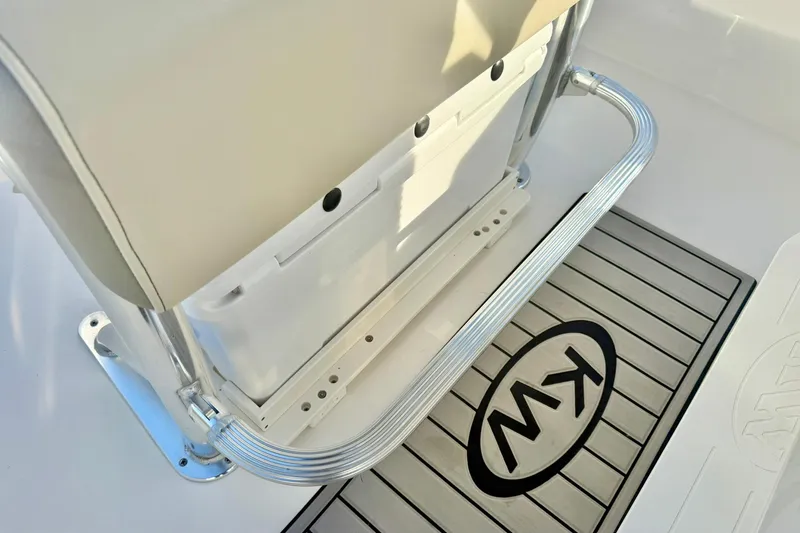 Slide: The Image of 2024 Key West 203 FS boat interior with cushioned seat and KW logo mat. - 24