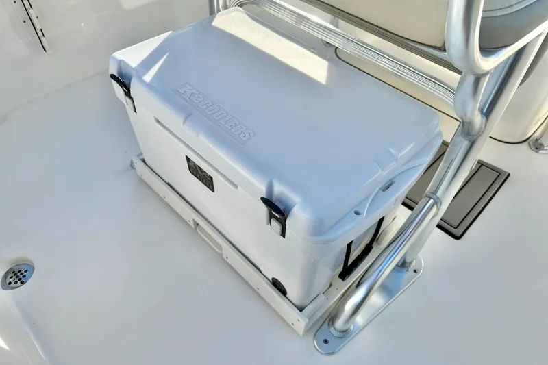 Slide: The Image of White cooler on 2024 Key West 203 FS boat, secured under a metal frame seat. - 26