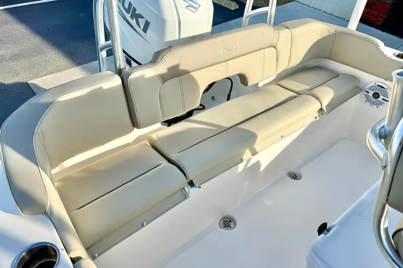 Slide: The Image of 2024 Key West 203 FS boat interior with beige seating and Suzuki engine. - 27